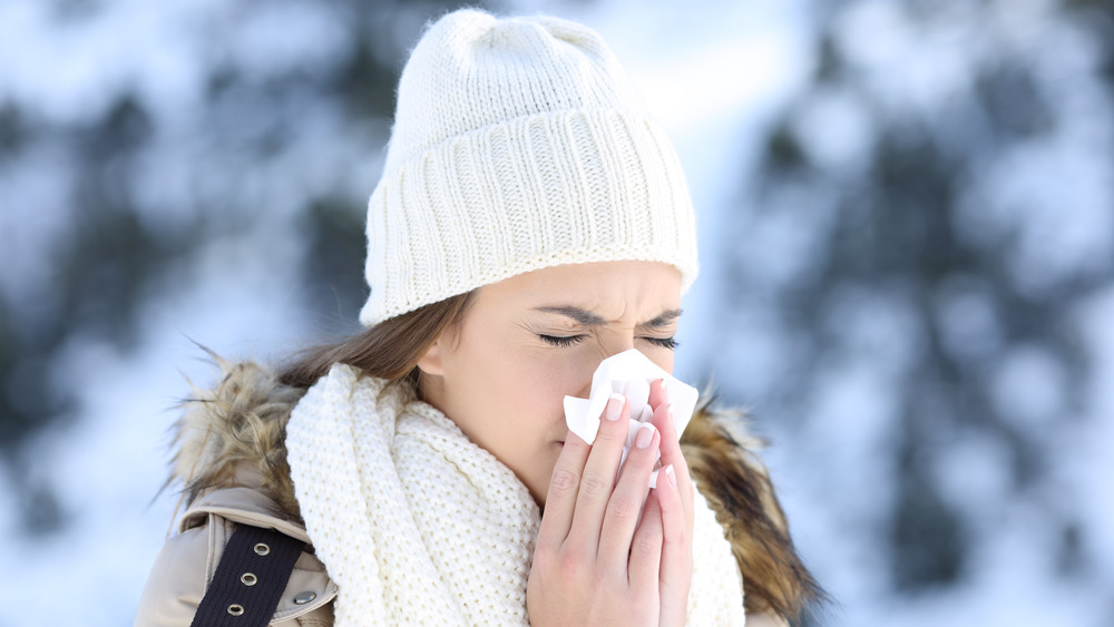 Woman with a cold nose in the snow