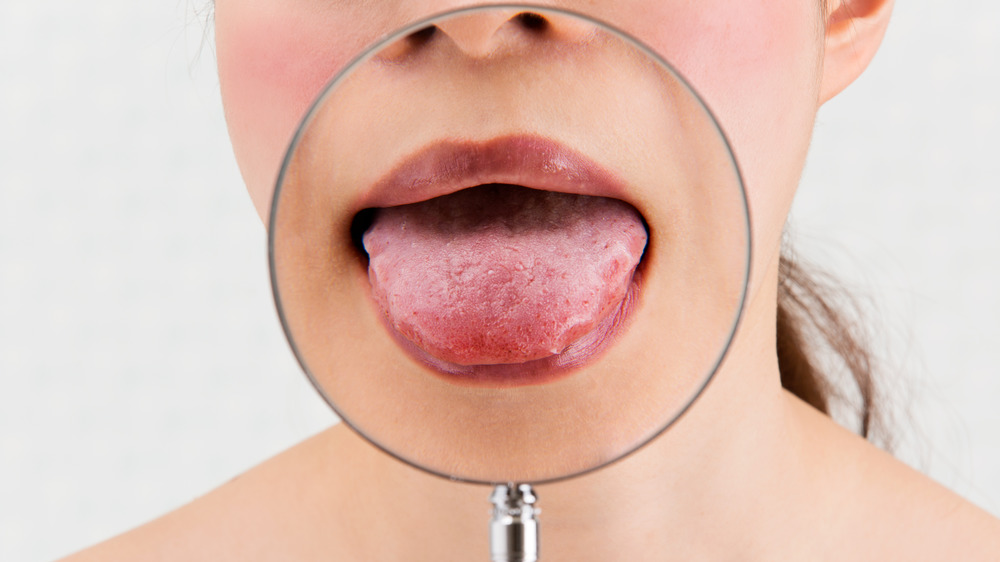 Tongue behind magnifying glass