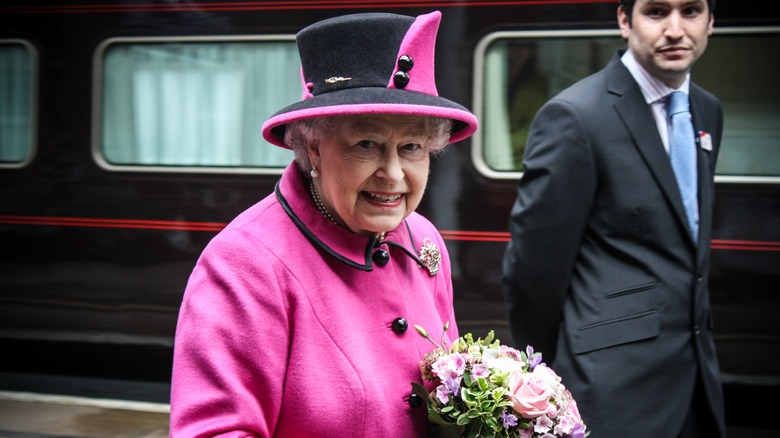 Queen Elizabeth II smiling with train