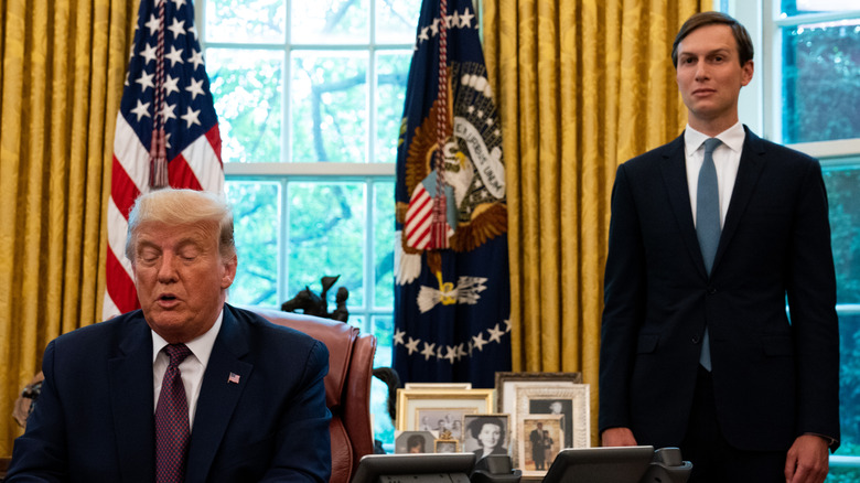 Jared Kushner stands behind Donald Trump