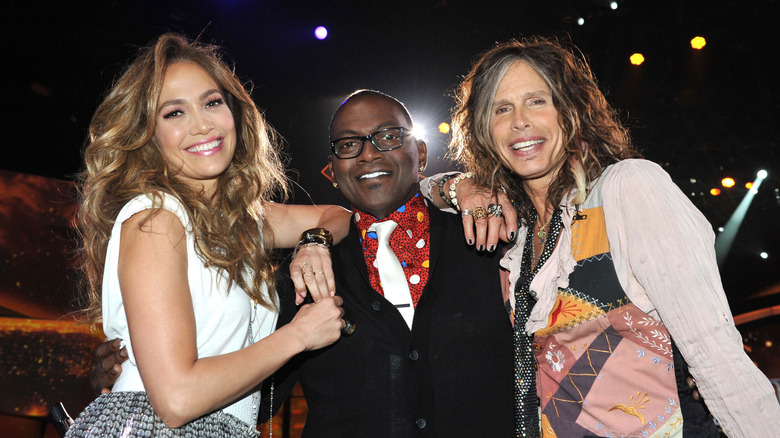 Jennifer Lopez, Randy Jackson, and Steven Tyler posing together.