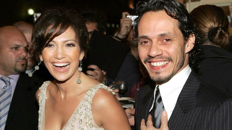 Close-up of Marc Anthony and Jennifer Lopez smiling in crowd