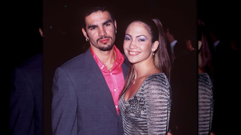 A smiling Jennifer Lopez posing with Ojani Noa