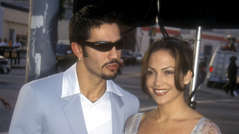 Ojani Noa wears sunglasses as wife Jennifer Lopez smiles for a photo