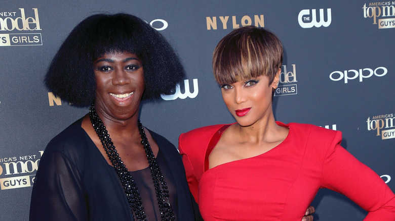 J. Alexander and Tyra Banks posing together at an ANTM event