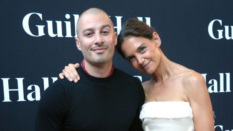 Katie Holmes smiling with her hand on Jason Bard Yarmosky's shoulder