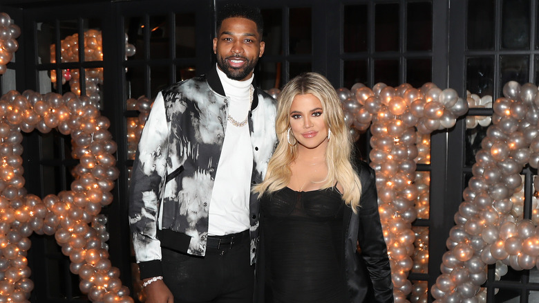 Tristan Thompson and Khloe Kardashian posing at event