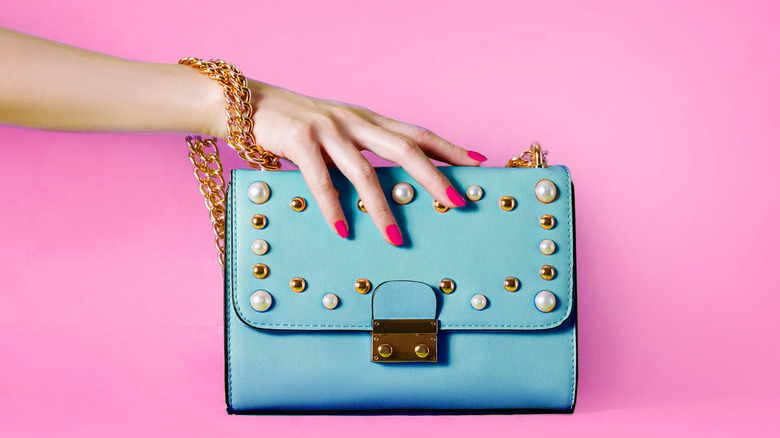 hand holding handbag