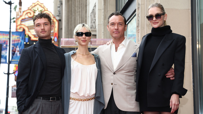 (l-r): Raff Law, Iris Law, Jude Law, and Phillipa Coan posing together at an event