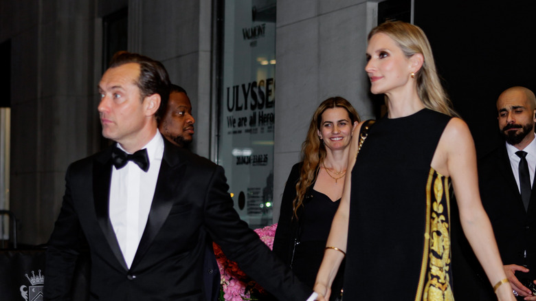 Jude Law and his wife, Phillipa Coan, walking and holding hands at an event