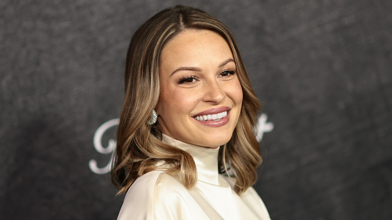 Image of Kayla Wallace smiling on the red carpet of an event