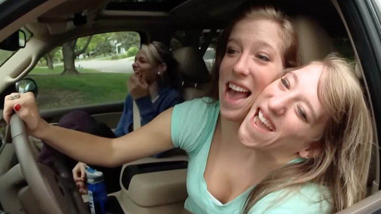 Abby and Brittany Hensel driving a car