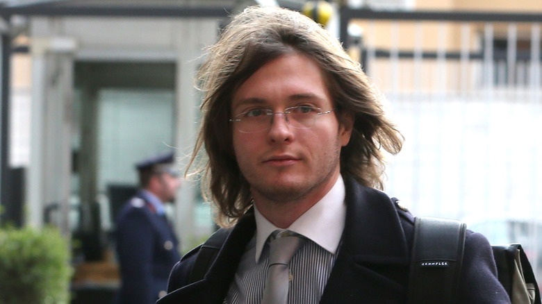 Raffaele Sollecito close-up walking in suit and glasses