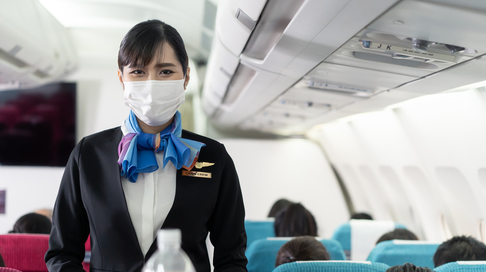 Flight attendant wearing mask