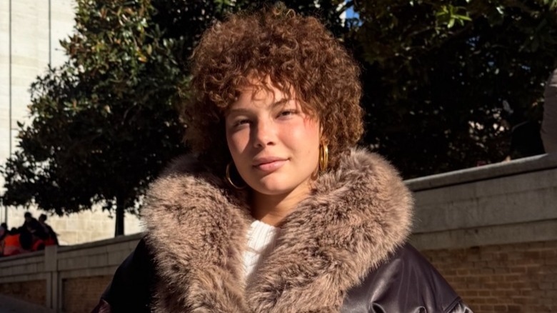 Isabella Strahan smiling while posing for a photo in a furry jacket