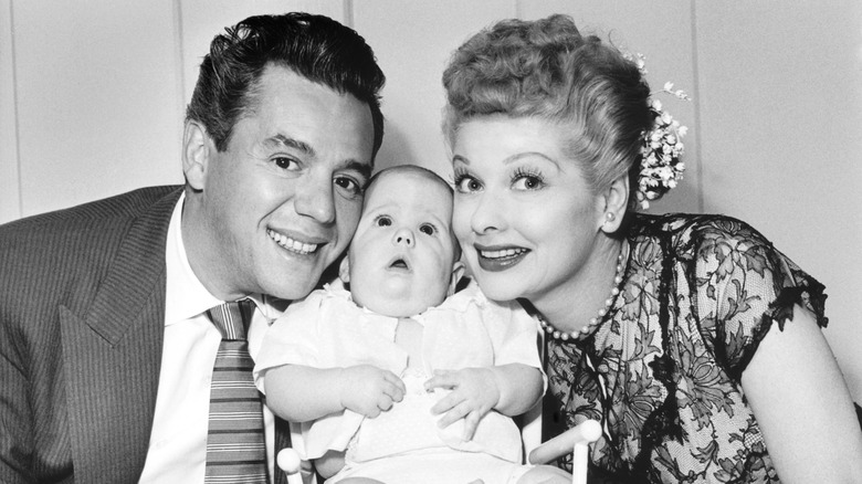 Desi Arnaz and Lucille Ball posing with their baby boy Desi Jr.
