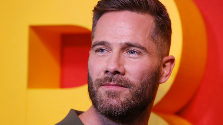 Luke Macfarlane poses on the red carpet