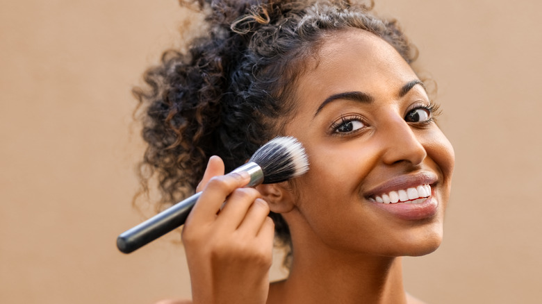 woman applying foundation with brush