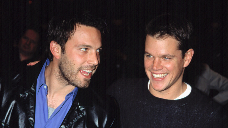 Ben Affleck in a black leather jacket beside Matt Damon