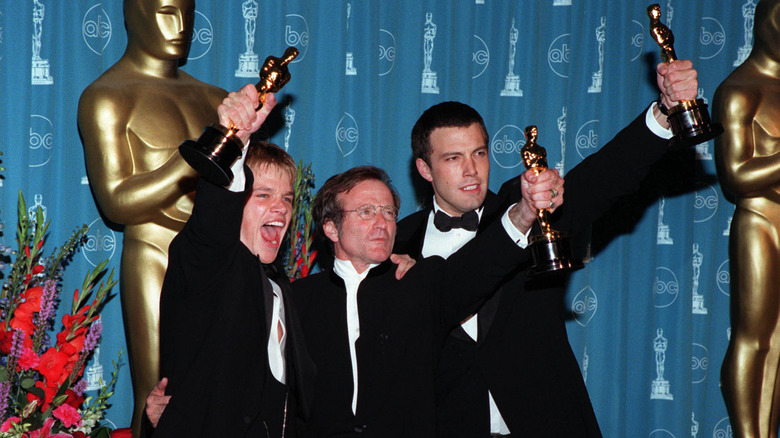 Ben Affleck, Matt Damon, and Robin Williams holding up their Oscars together
