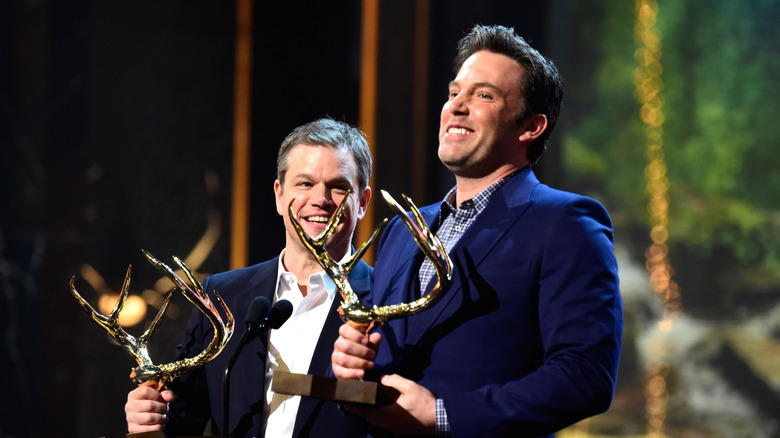 Ben Affleck and Matt Damon holding their Guys of the Decade awards