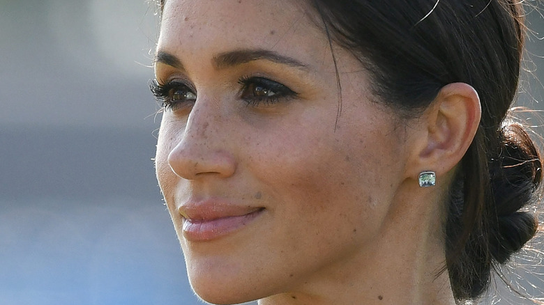 Meghan Markle in profile grinning