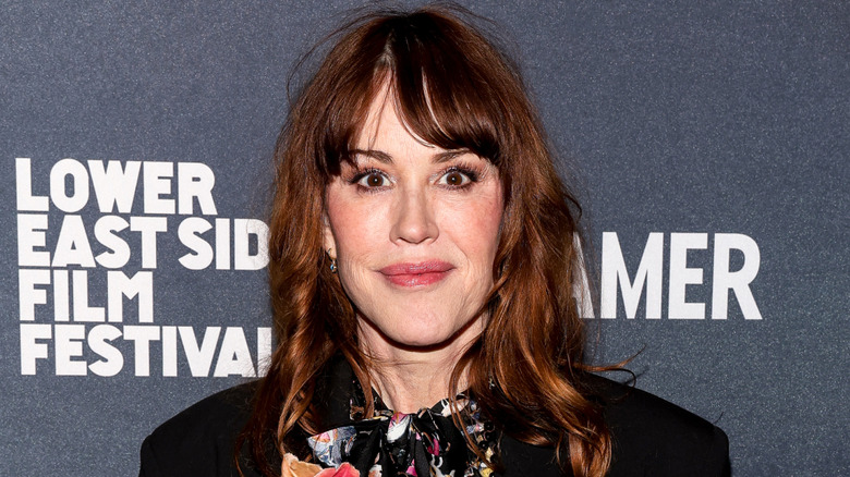 Molly Ringwald smiling while posing at a film festival
