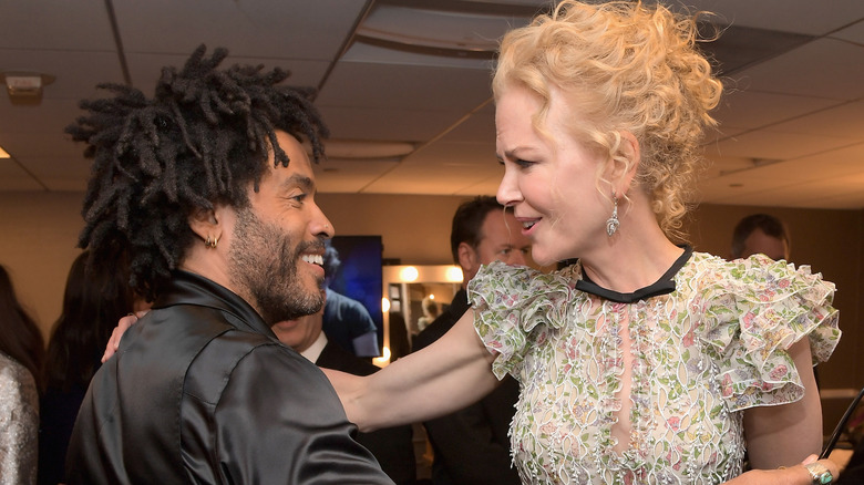Lenny Kravitz and Nicole Kidman greeting each other at an event