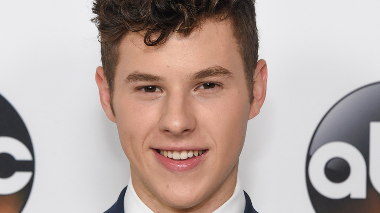 Nolan Gould smiles at an event