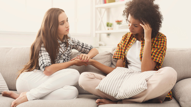 women sitting having serious conversation