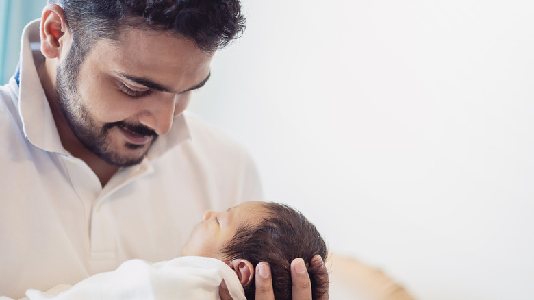 man looking lovingly down at baby