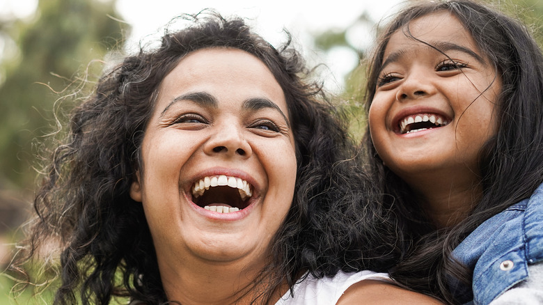 mom and daughter outside smiling