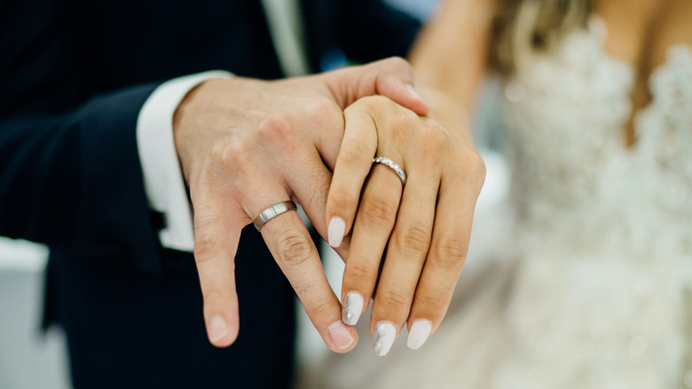 Married couple, close up of wedding rings