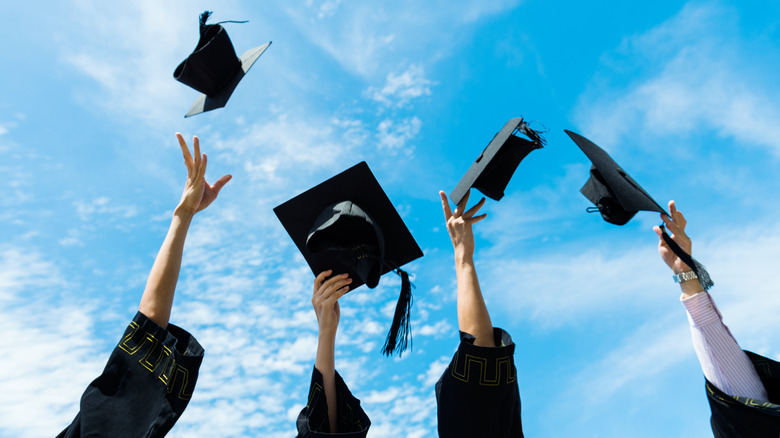 Graduates throw caps 