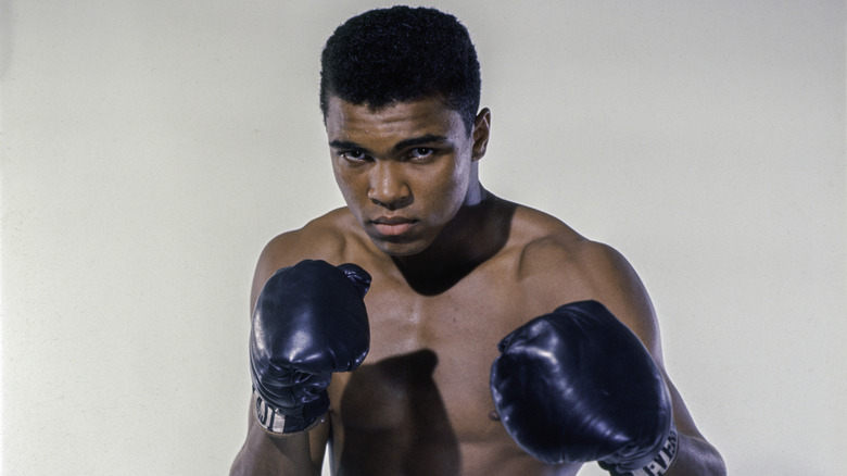Muhammad Ali wearing boxing gloves