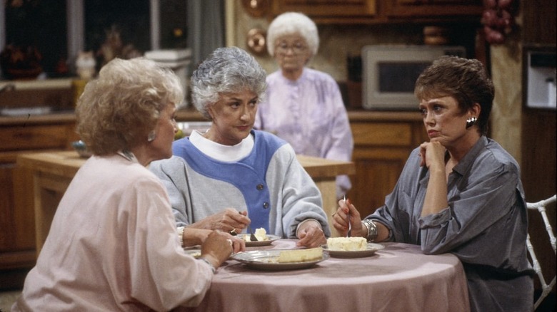 The cast of The Golden Girls eating cheesecake in the kitchen