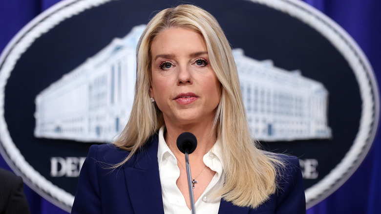 Pam Bondi speaking at a podium in a blue suit