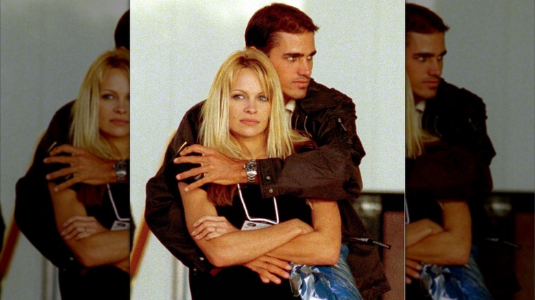 Kelly Slater with his arm around Pamela Anderson.