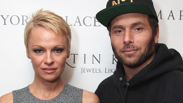 Pamela Anderson and Rick Salomon appearing on a step-and-repeat together.
