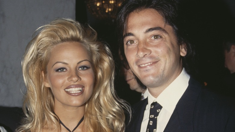 Pamela Anderson and Scott Baio smiling at an event in 1991.