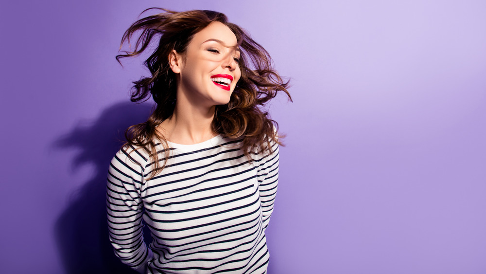 woman with curly hair smiling