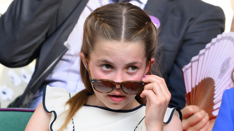 Princess Charlotte removing her glasses at Wimbledon