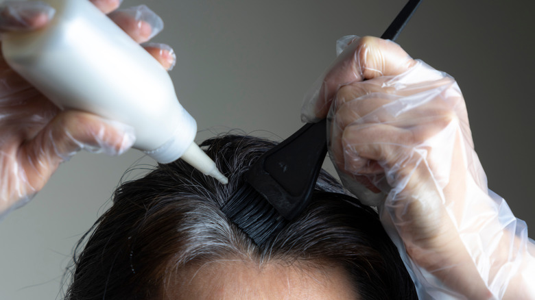 Woman applying hair dye