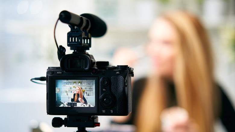 Camera filming a beauty influencer 