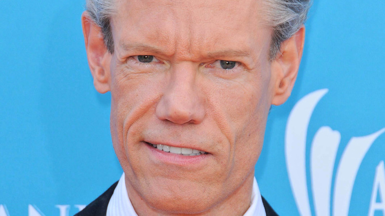 Randy Travis smiles on the red carpet