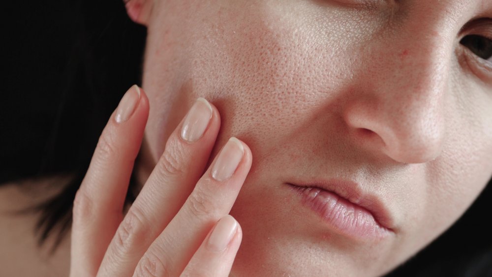 Woman examining her pores