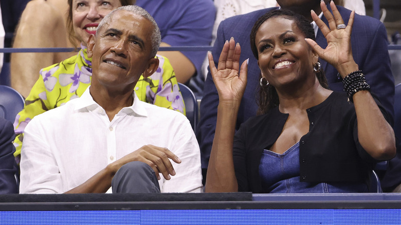 Barack and Michelle Obama smiling at an event 