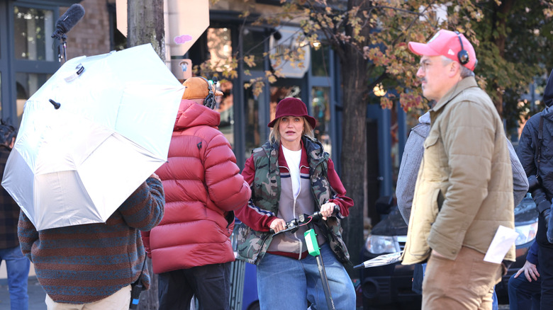 Cameron Diaz riding Lime scooter on street surrounded by film crew on the set of "Bad Day"
