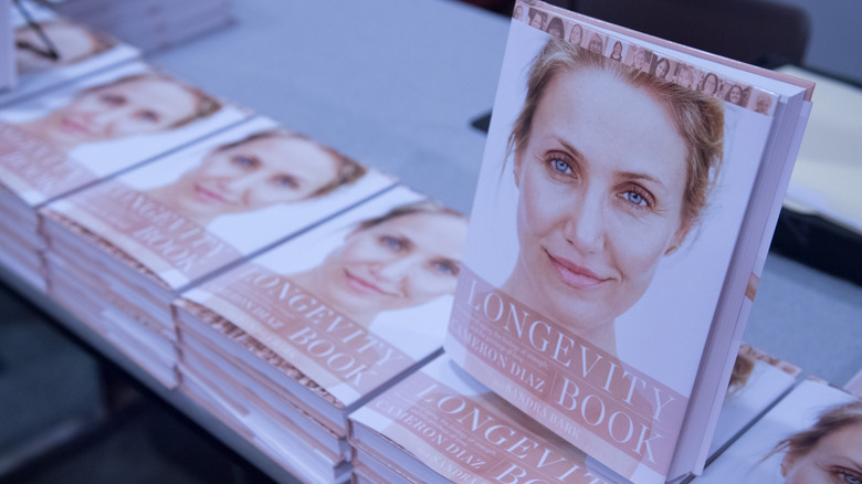 Several copies of "The Longevity Book" by Cameron Diaz on display in a book store