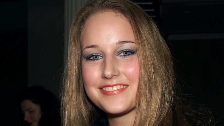 Leelee Sobieski smiling, wearing heavy makeup